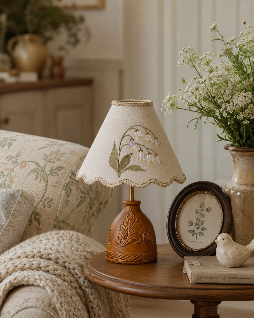 Botanical embroidered lamp on round wooden side table with framed botanical print and decorative bird accent