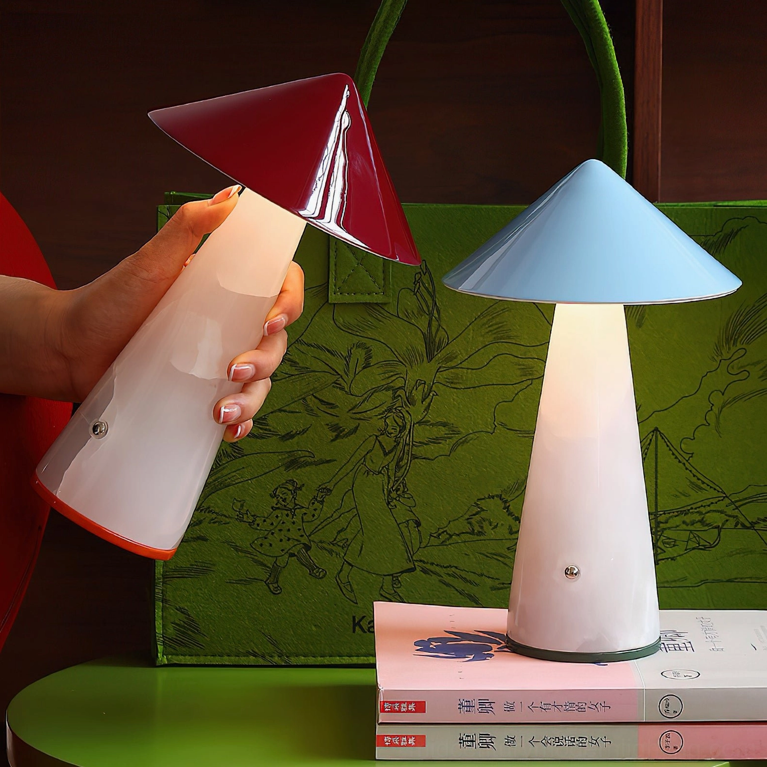 Maisie cordless lamp in deep red with white jade base held in hand, displaying premium materials and portable rechargeable design
