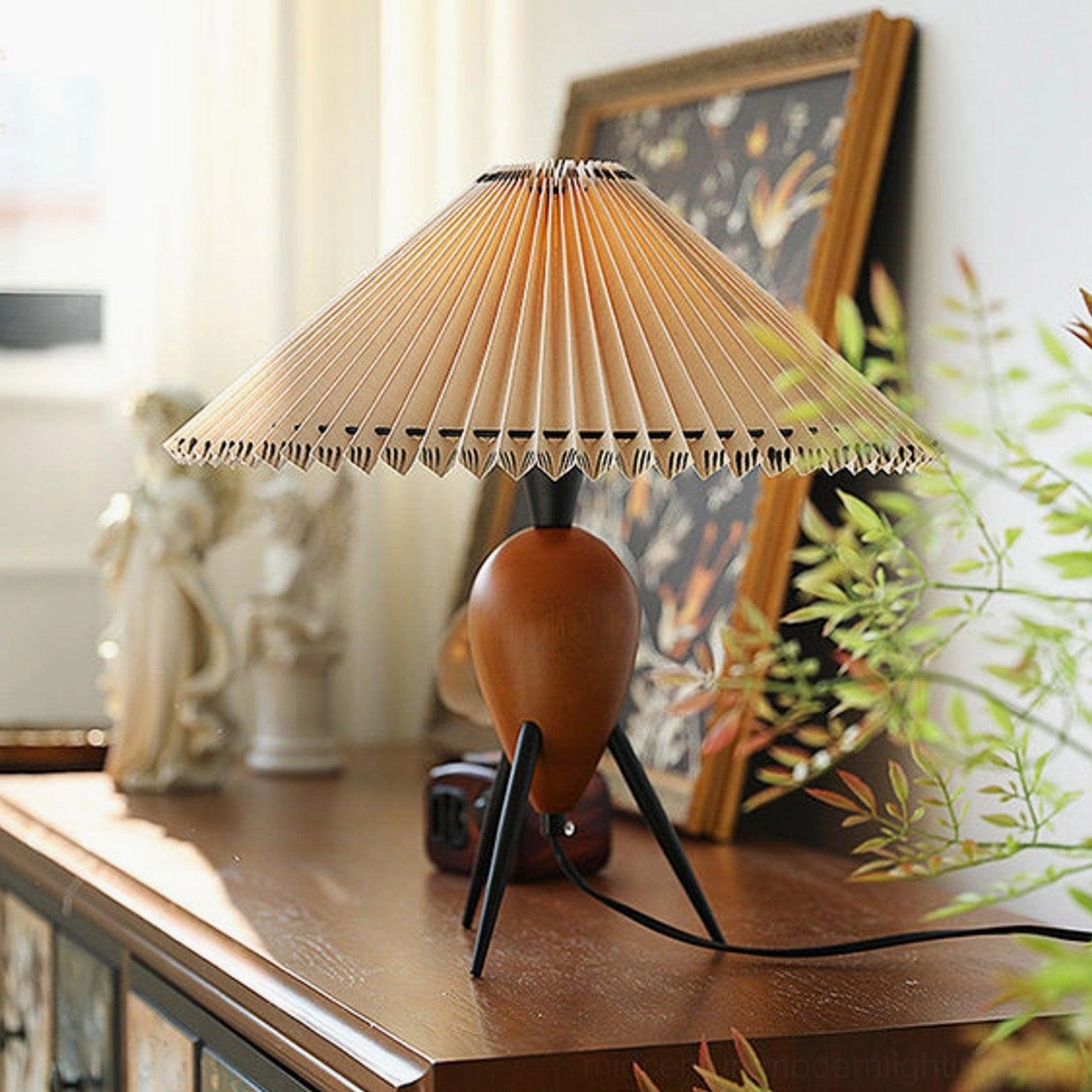 Makie tripod table lamp styled on retro dresser with sculpture and framed artwork, botanical aesthetic