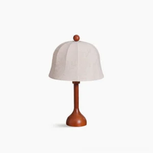 Malcolm mid-century modern table lamp with white embroidered dome shade and brown wooden base, studio front view