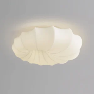 Close-up detail of malibu off-white flush mount lamp showing matte finish and fluted shell surface