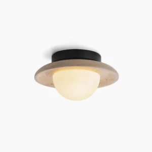Malo travertine ceiling flush mount light fixture close-up showing porous stone ring and matte black metal base on white background