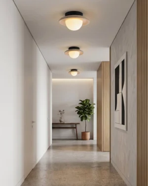 Multiple Malo travertine ceiling lights installed in modern residential hallway creating warm ambient lighting corridor
