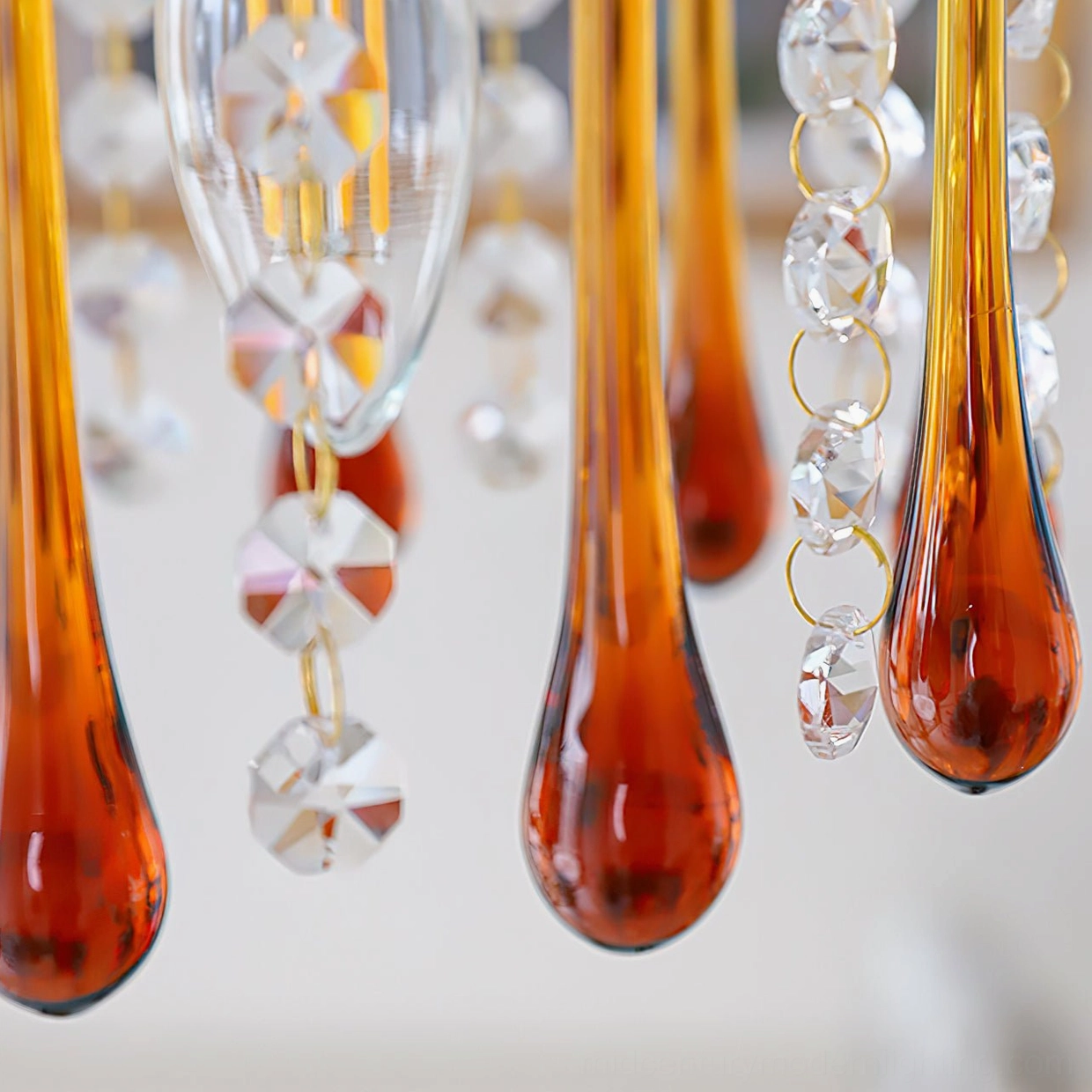 Maltose crystal ceiling light with polished brass frame and teardrop glass pendants in studio lighting