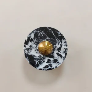 Installed marble wall lamp on beige interior wall demonstrating compact luxury design in natural interior setting