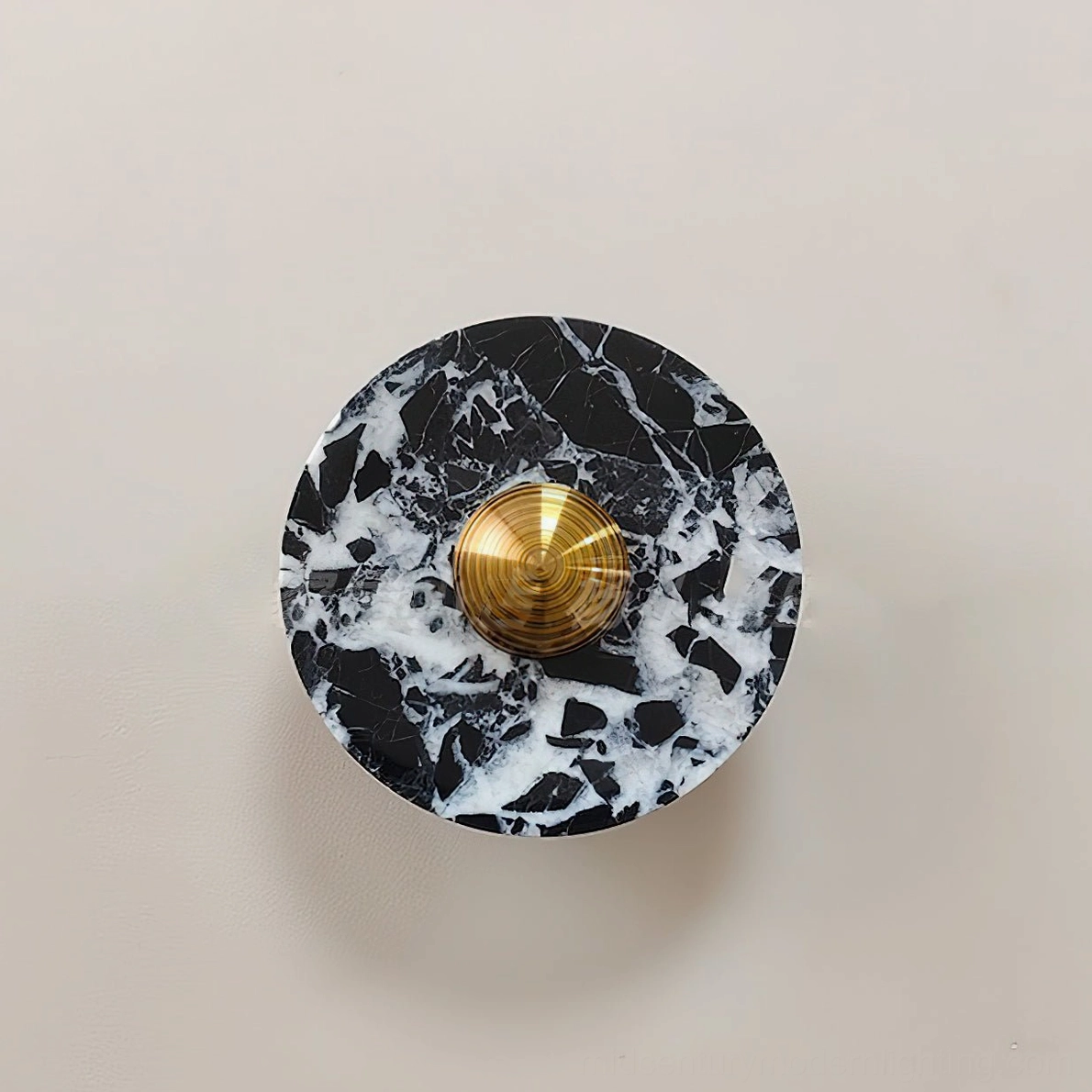 Installed marble wall lamp on beige interior wall demonstrating compact luxury design in natural interior setting