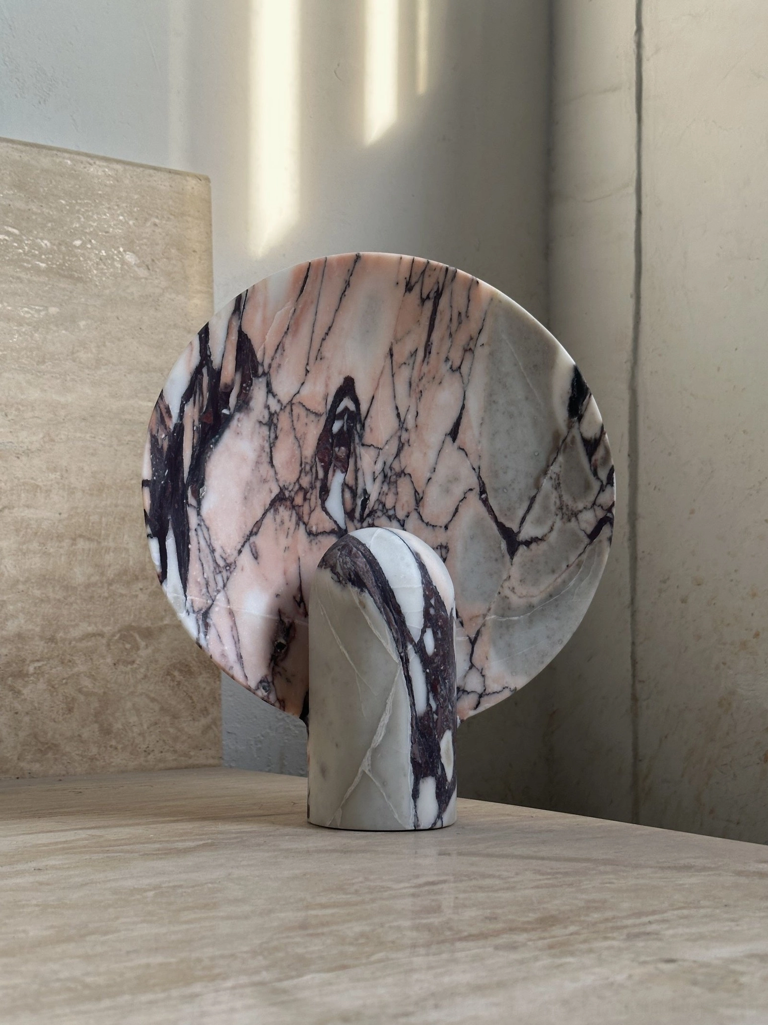 Marble table lamp detail showing cord management and push-button switch control design for seamless functionality
