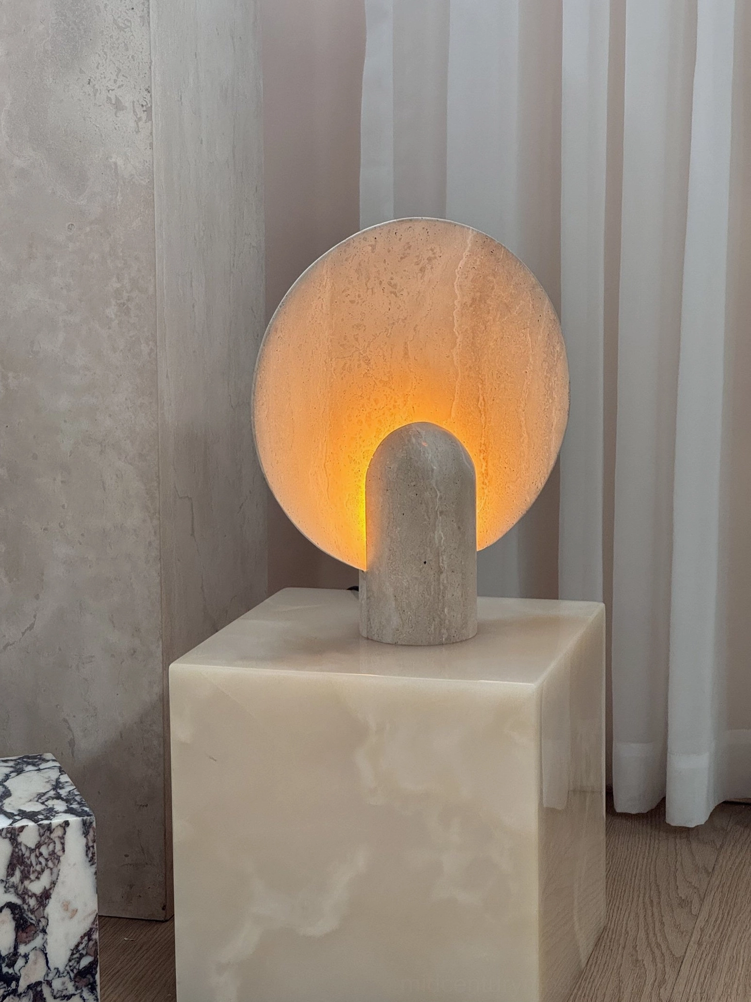 Marble table lamp positioned in gallery retail environment demonstrating architectural quality and commercial design appeal