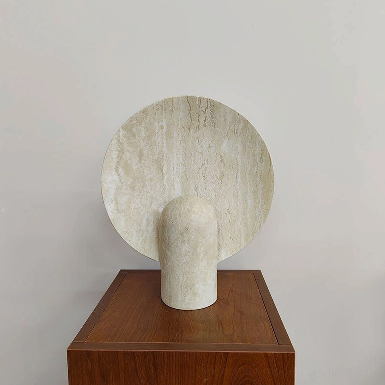 Marble table lamp positioned on modern furniture piece emphasizing minimalist design principle that form follows function