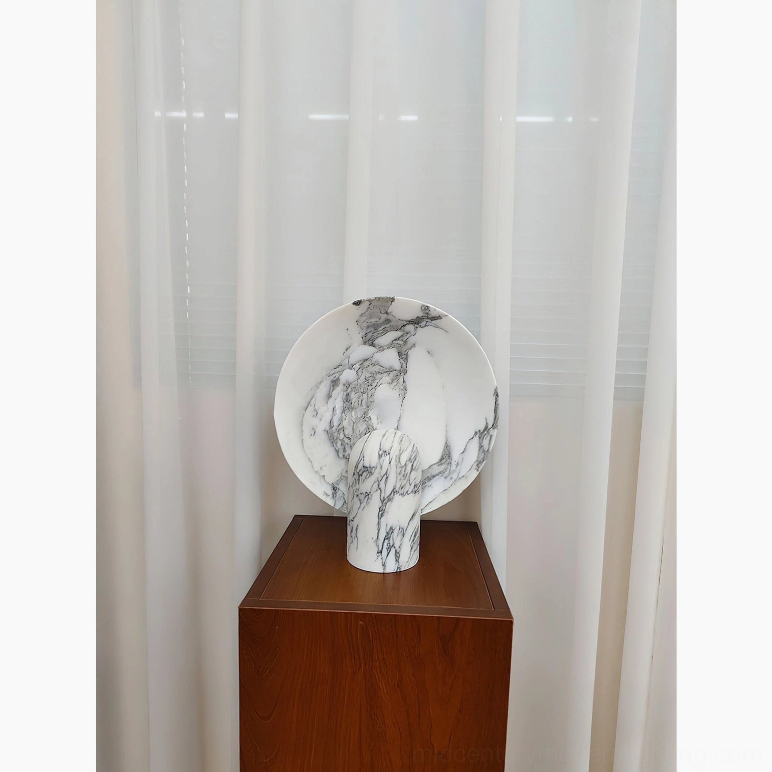 Marble table lamp detail of round diffuser panel and light emission creating warm ambient illumination for modern spaces
