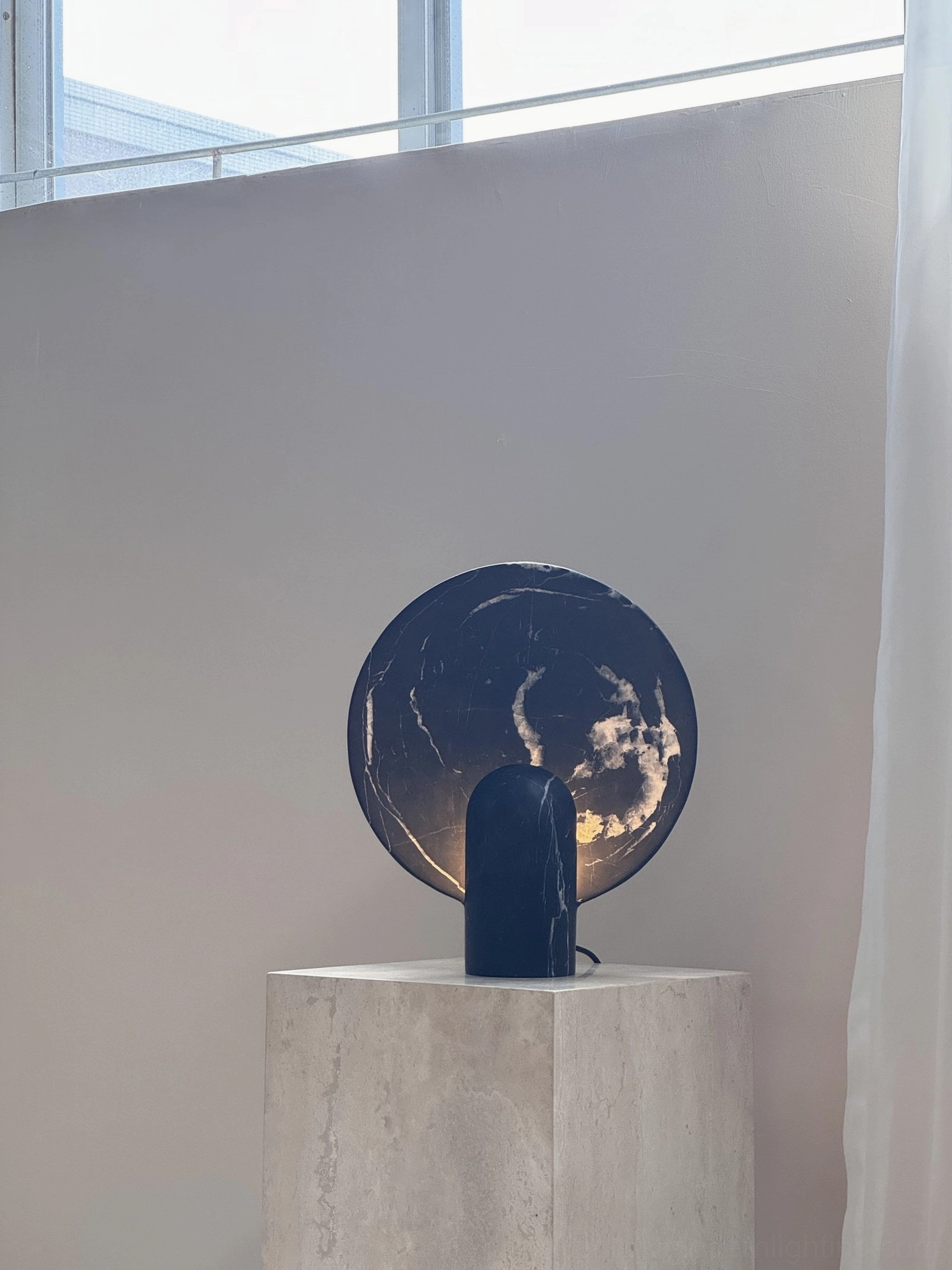 Side profile of marble table lamp showing cylindrical base and round marble panel construction detail mid-century design