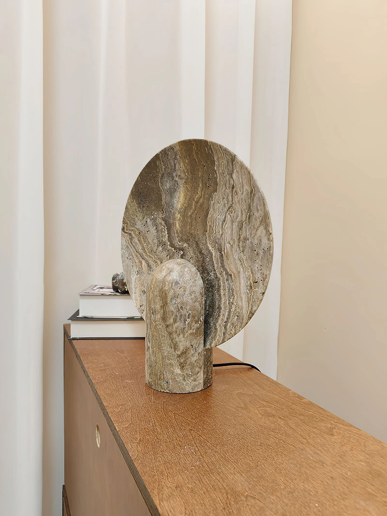 Detail shot of marble table lamp spherical diffuser showing light transmission through premium natural stone material