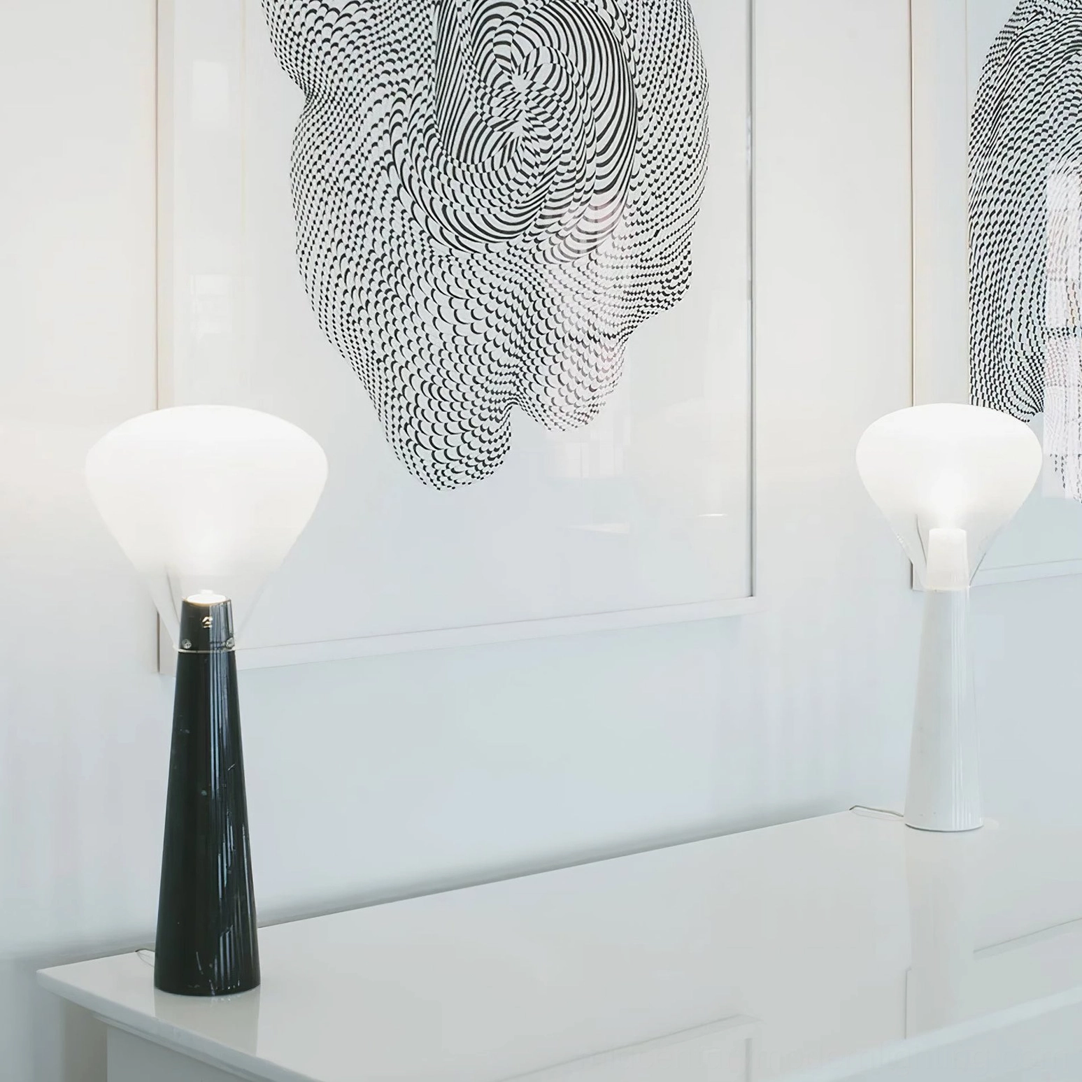 Two decorative marble lamps on modern white desk, black and white base variations
