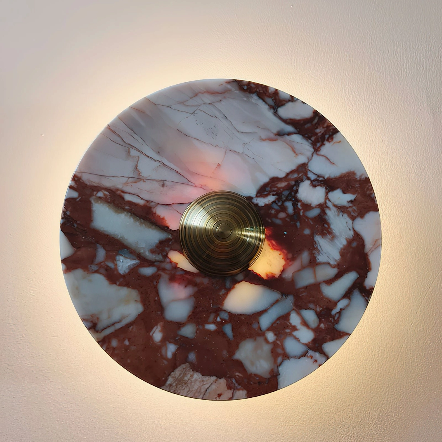 Geometric marble wall lamp design photographed flat lay overhead showing circular marble disc composition