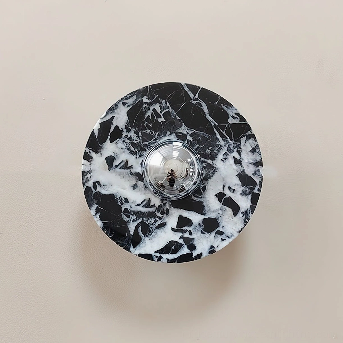 Standard marble wall lamp design with integrated LED bulb socket visible in center of circular marble disc