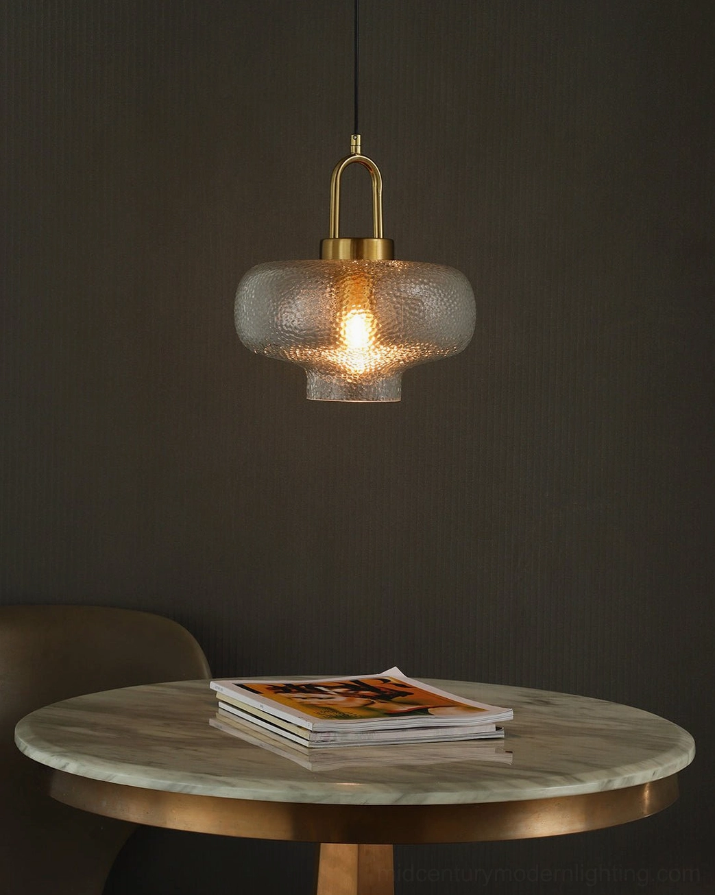 Marco pendant lamps suspended at varying heights in contemporary interior design setting with modern furniture