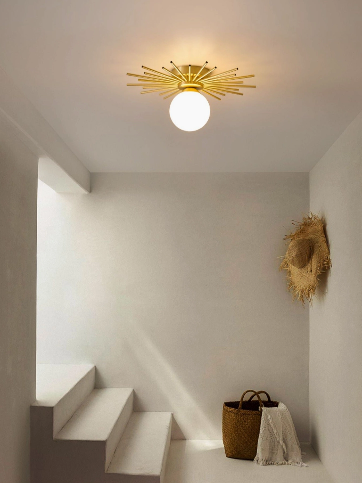 Margaret mid-century modern ceiling fixture detail, brushed brass rods radiating from frosted globe center