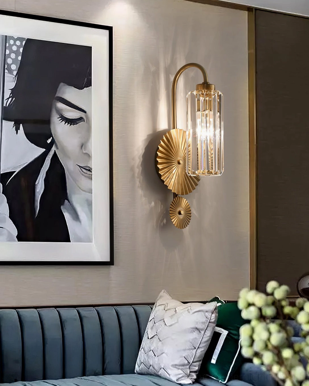 Maria brass wall sconce in contemporary living room beside tufted sofa with modern home decor
