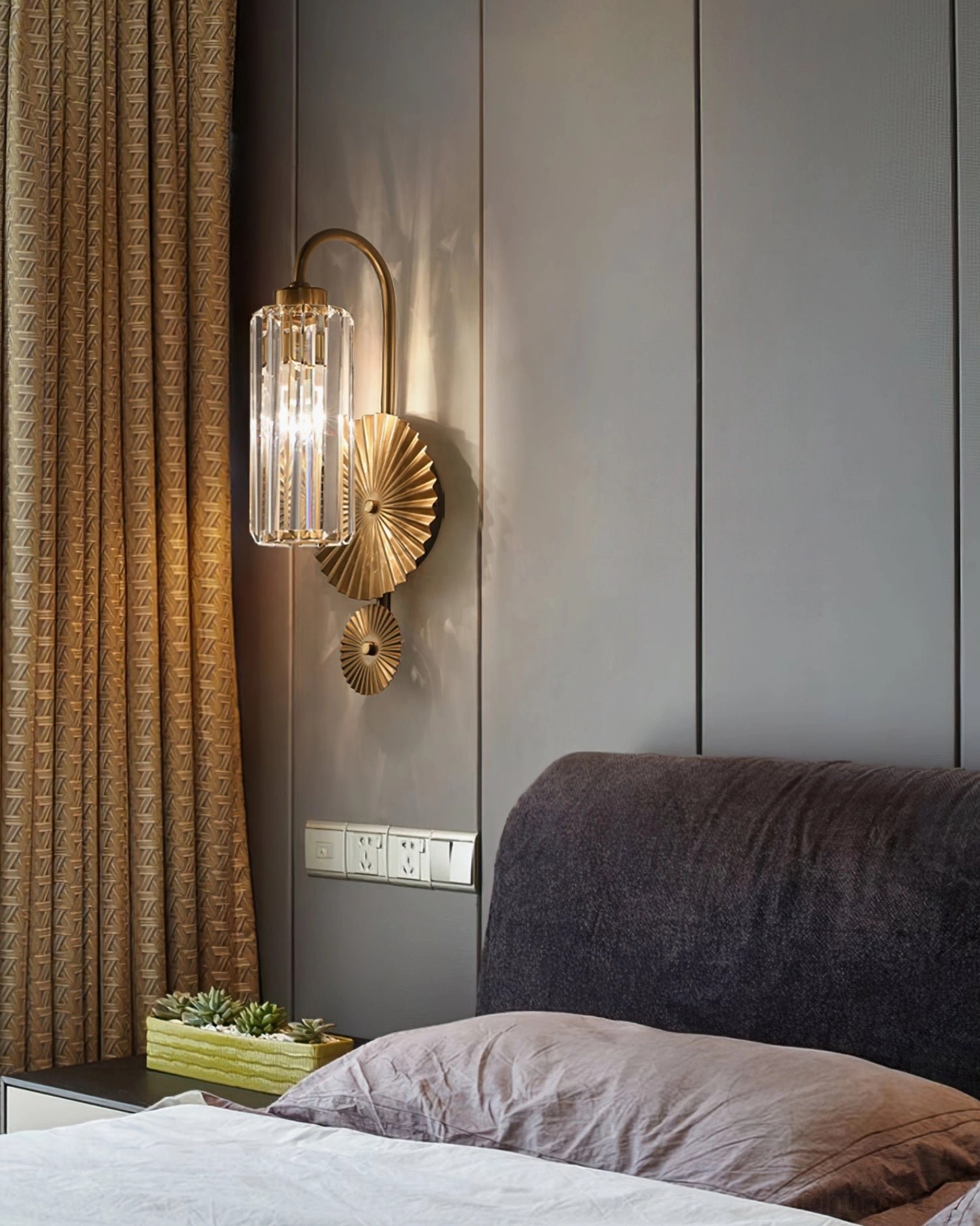 Maria crystal wall lamp installed in modern master bedroom mounted on gray paneled wall beside bed