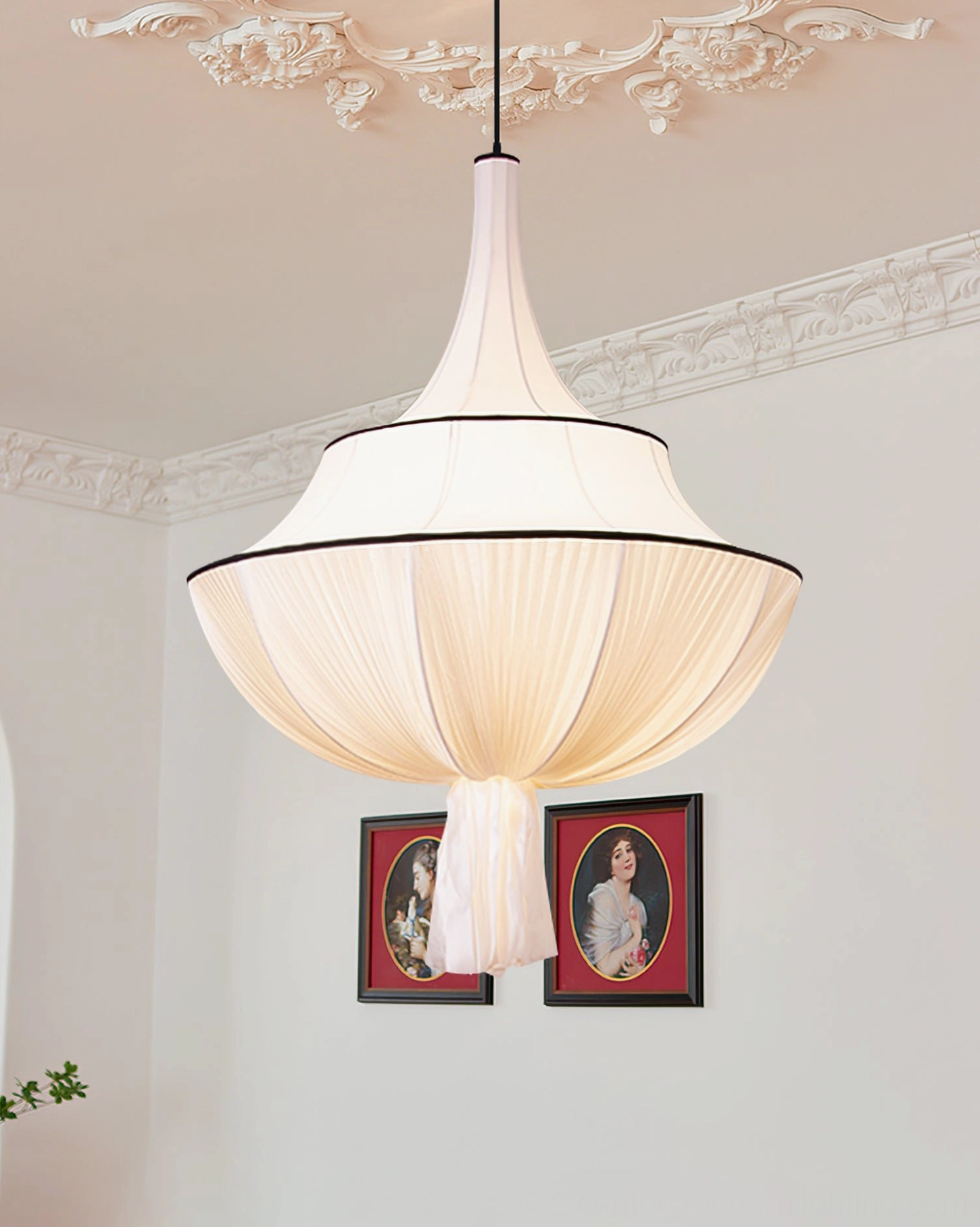 Marianna pleated pendant light with black trim and tassel decoration, side view in elegant living room with framed art