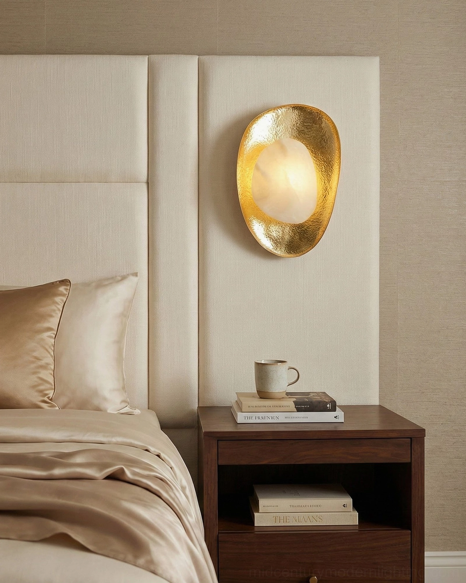 Modern alabaster wall lamp mounted on neutral bedroom wall, minimalist luxury design