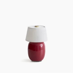 Marie ceramic table lamp with red base and white fabric shade, studio product photography