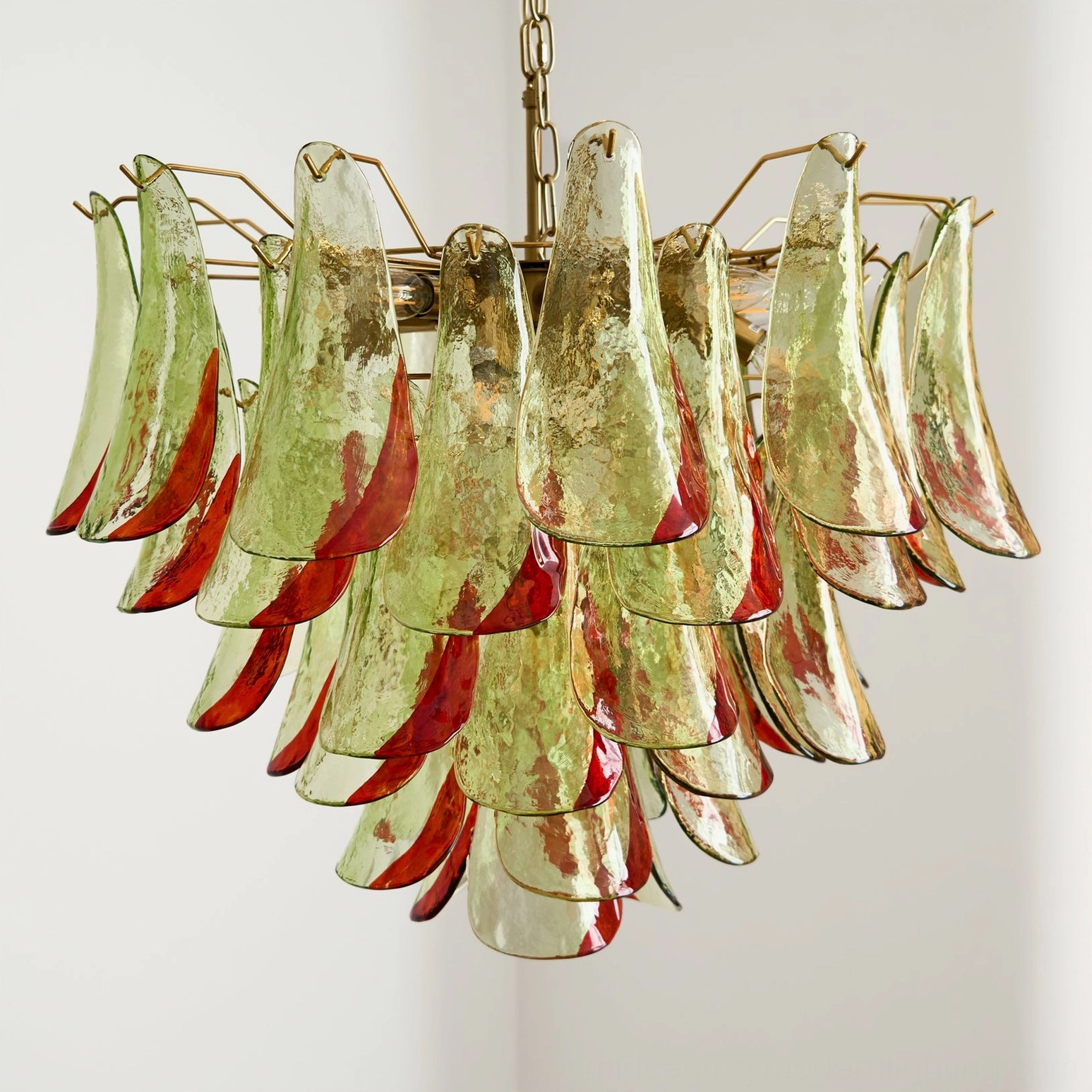 Close-up detail of Marielle Murano glass chandelier showing individual hand-blown glass petals in amber and green tones