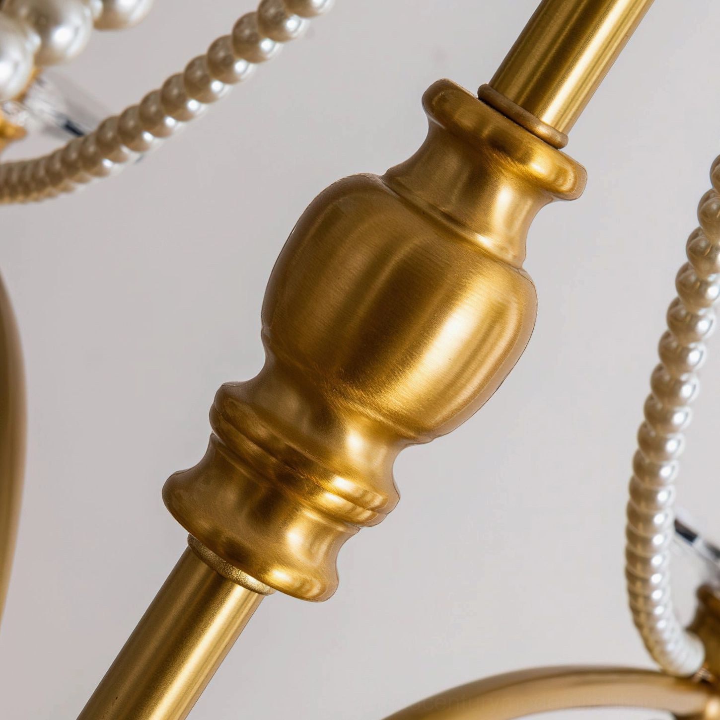 Macro photography of Mariposa chandelier brass pole and crystal component detail