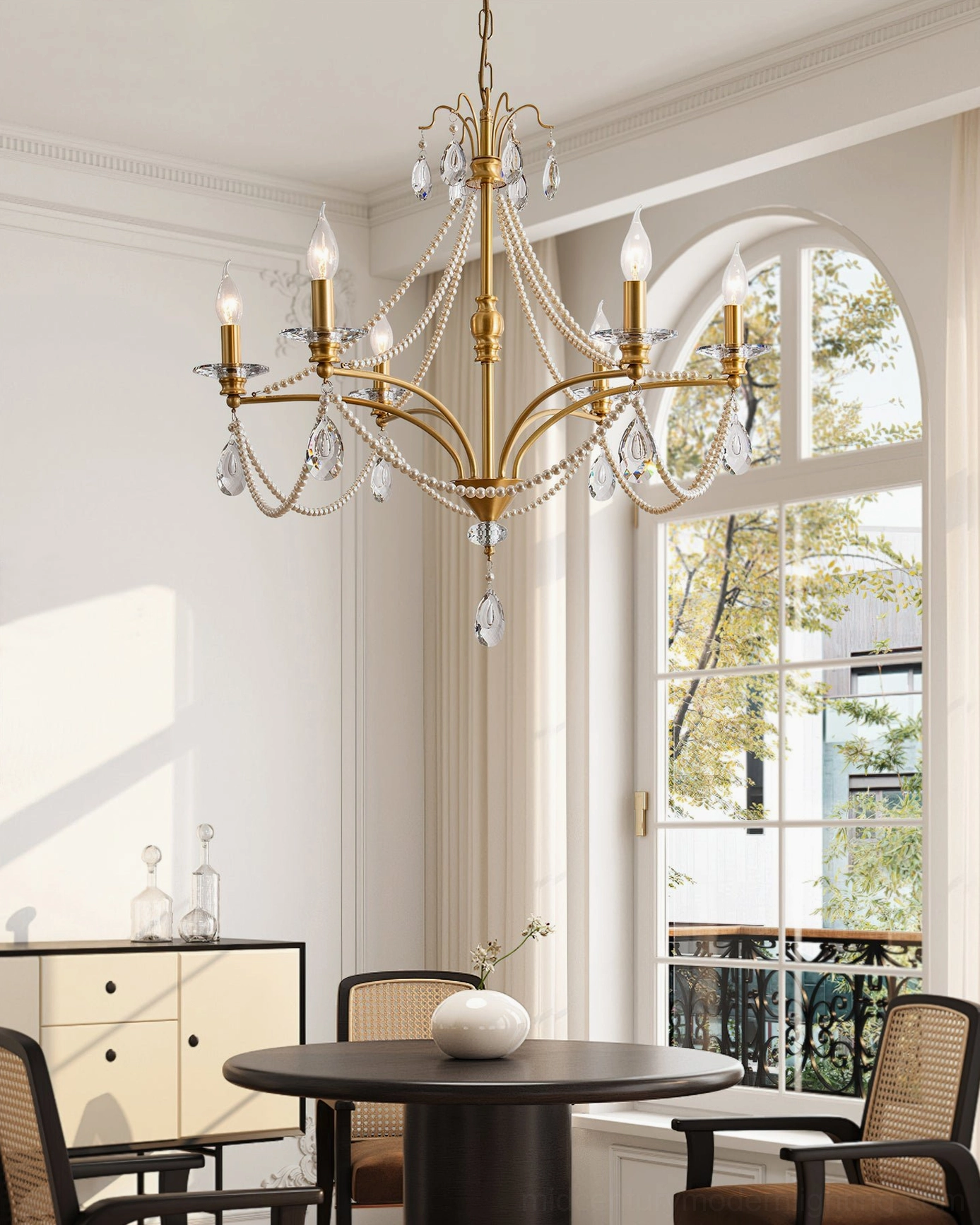 Mariposa crystal chandelier installed in French-style dining room with arched window, illuminated hanging view