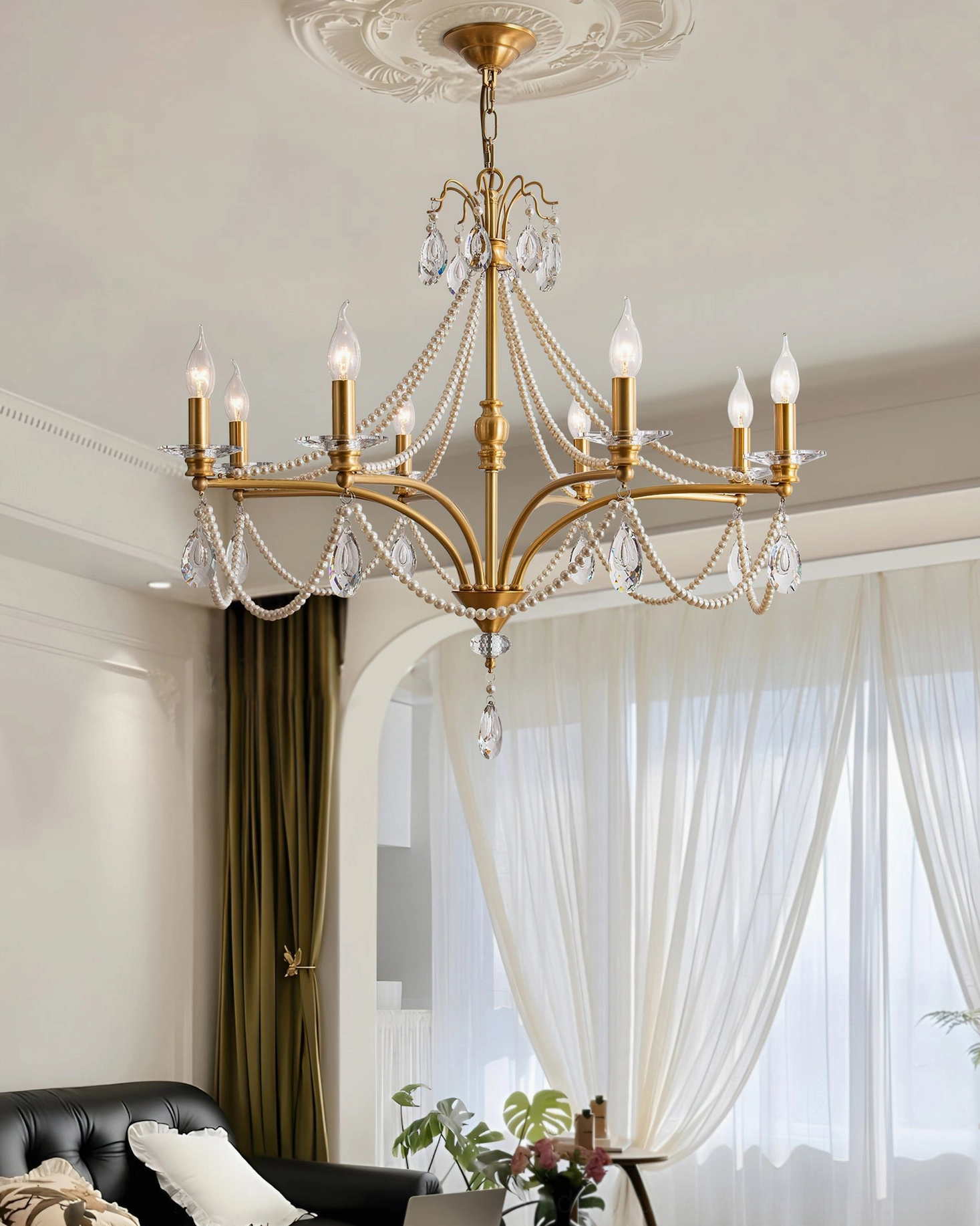 Elegant Mariposa crystal chandelier in modern French living room with sheer curtains and warm ambient lighting
