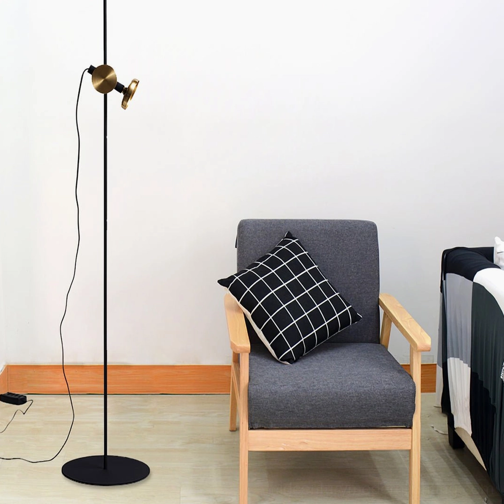 Marquina floor lamp spotlight adjustable head, brass fixture rotation mechanism and black metal construction