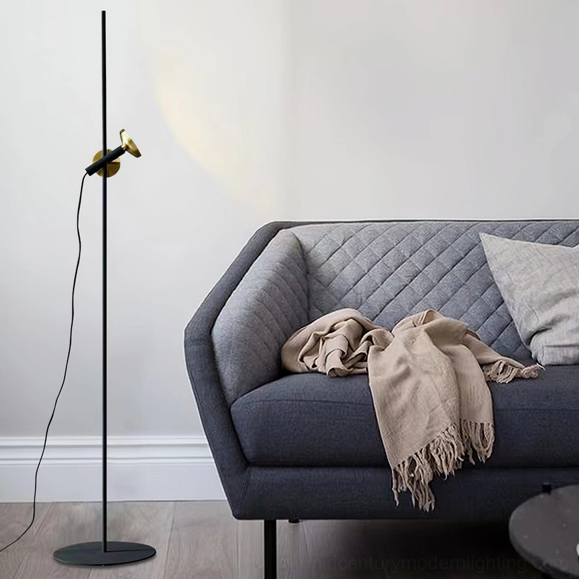 Close-up detail of Marquina floor lamp brass spotlight head and articulated joint mechanism