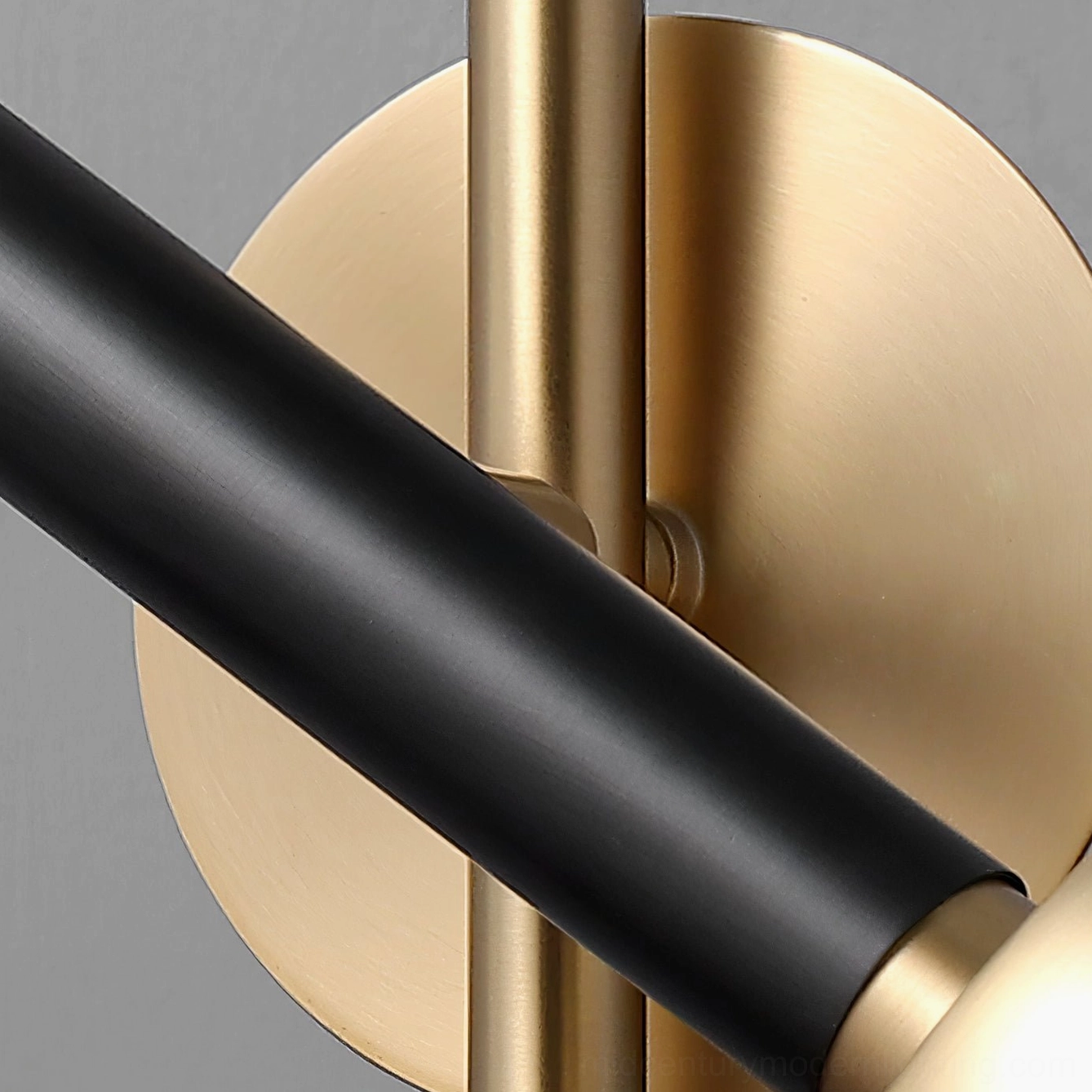 Close-up detail of Marquina lamp brass coupling and matte black metal arm joint
