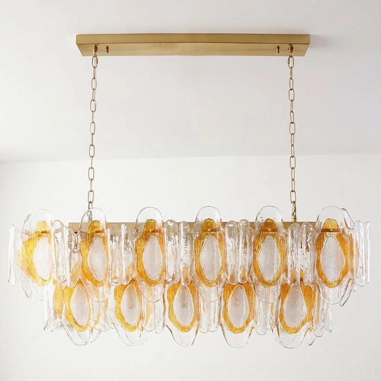 Marrina sculptural glass chandelier compact size model featuring amber and clear glass petals with brass gold frame hardware