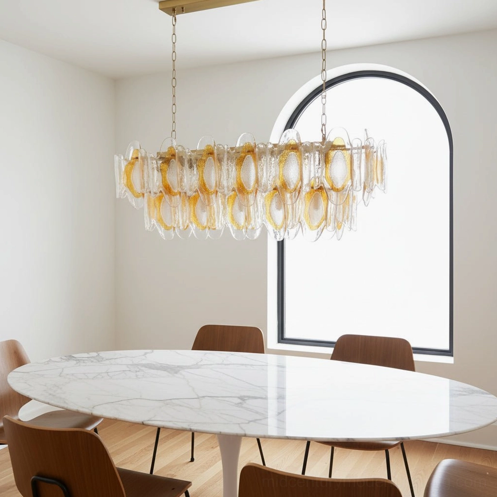 Marrina chandelier eye-level side view in minimalist dining room with arched window showing layered clear and amber glass trim