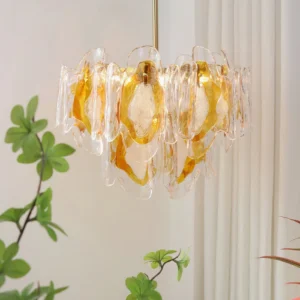 Marrina tiered amber glass pendant chandelier three-quarter view in modern interior with sheer curtains and greenery