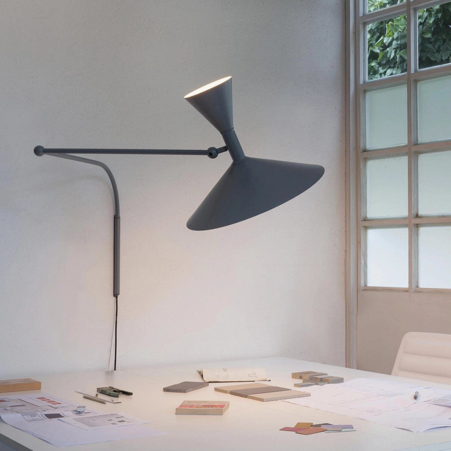 Dual-head Marseille dark grey swing arm wall lamp in modern home office setting above desk