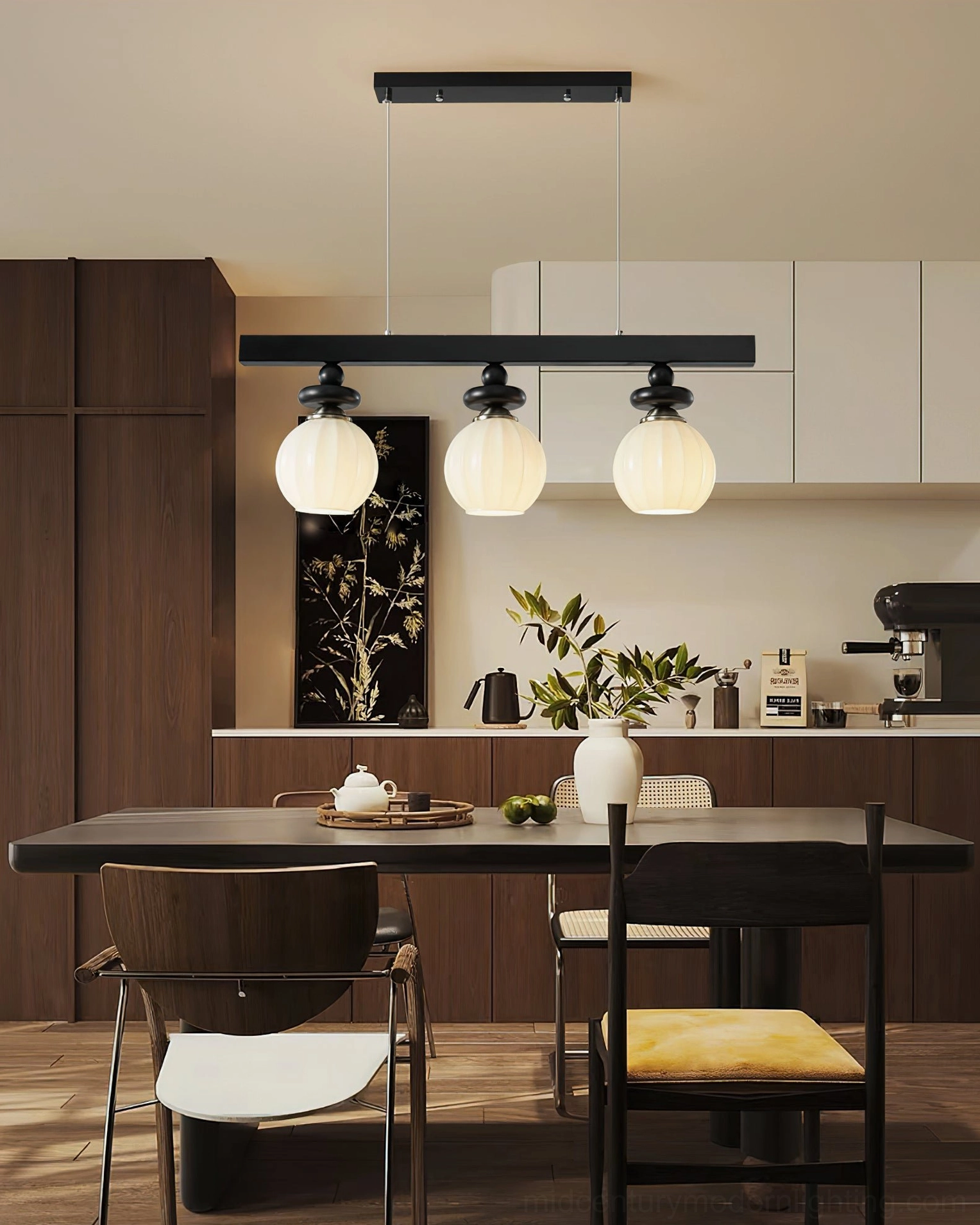 Maru 3-light linear pendant installed above open kitchen-dining area complementing dark wood cabinetry and warm tones
