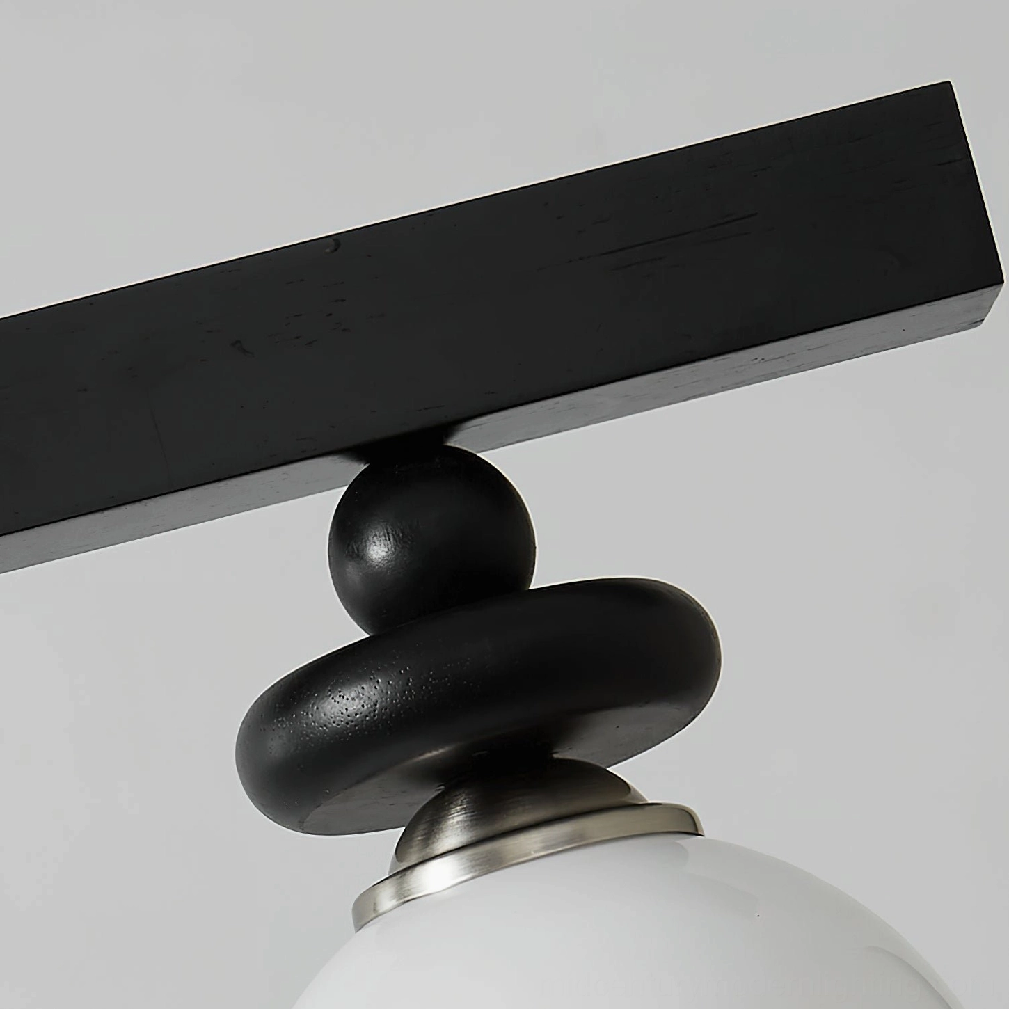 Maru linear pendant light fixture showing metal rail system and multiple frosted glass globes for contemporary dining applications
