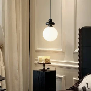 Maru ribbed glass pendant installed in vintage bedroom corner creating warm ambient lighting with side profile of frosted glass shade