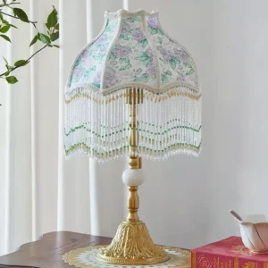 Masa vintage Tiffany style table lamp three-quarter angle showing white decorative pole accent and green beaded trim on bedroom side table