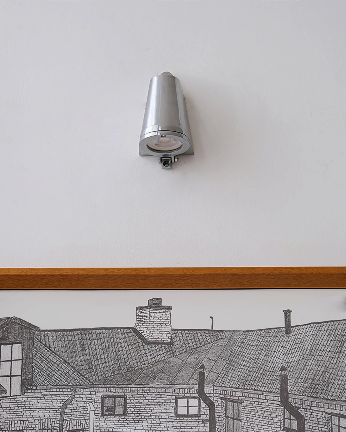 Mast polished silver wall light with exposed cone head minimalist design