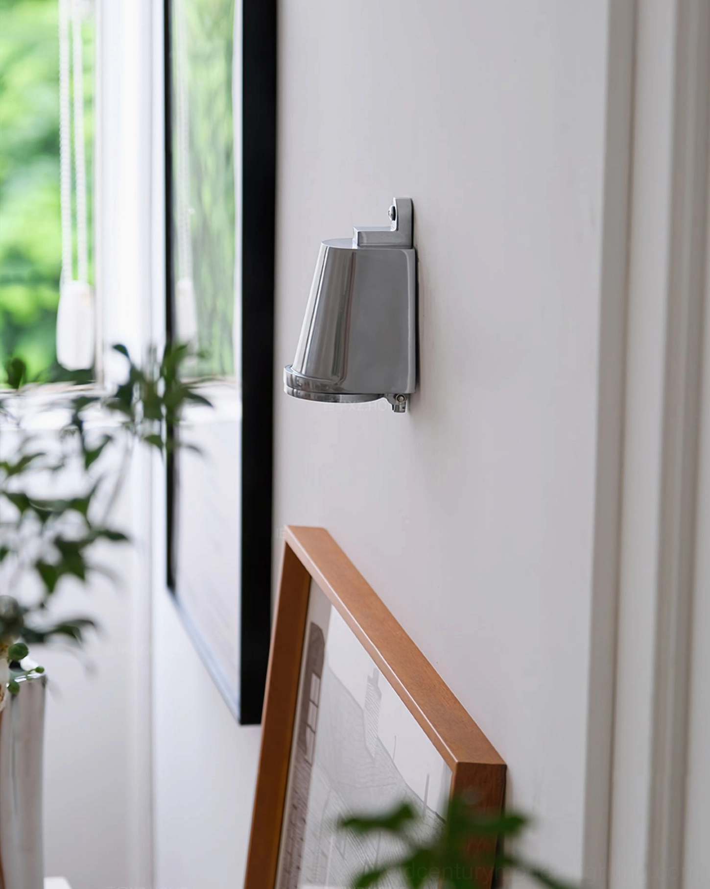 Mast gray wall spotlight in warm minimalist entryway with window lighting