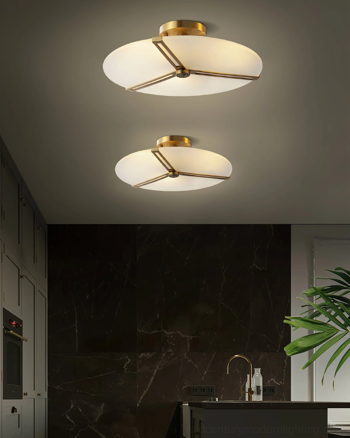 Dual geometric brass ceiling lamps in contemporary kitchen with dark marble backsplash