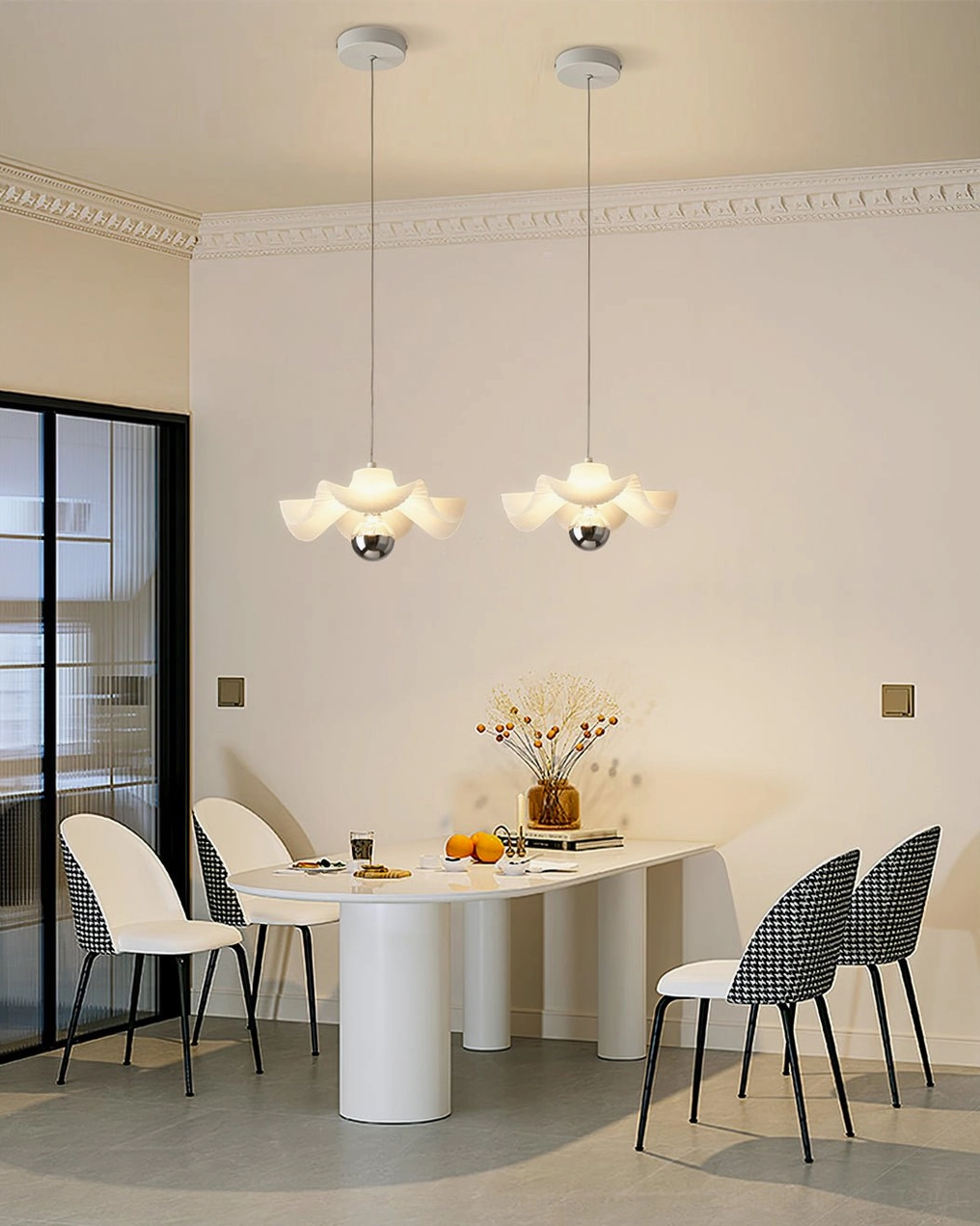 Pair of modern pleated pendant lamps illuminating long dining table in contemporary space