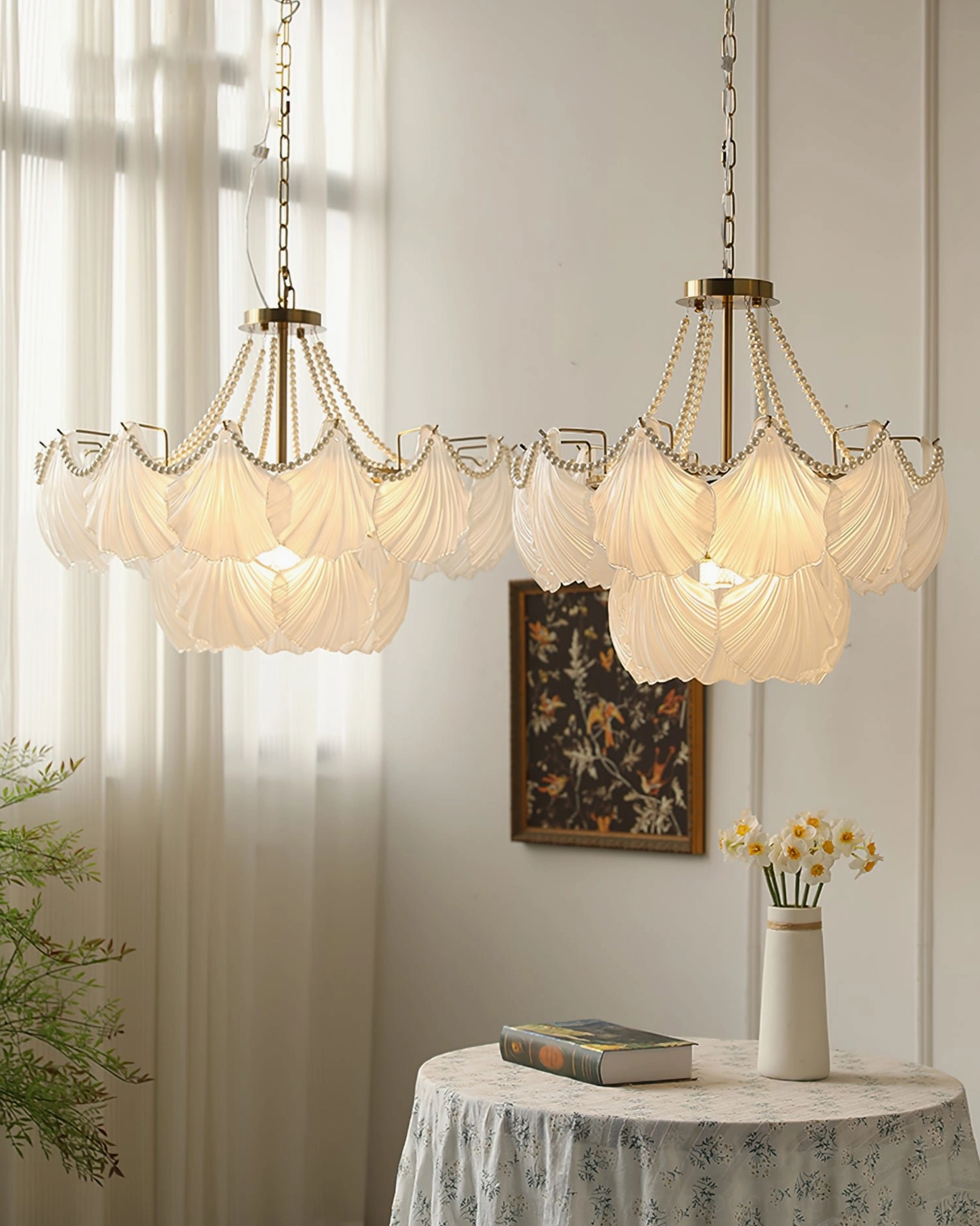 Multiple matching scallop shell chandeliers in vintage dining room with neutral tones and brass fixtures