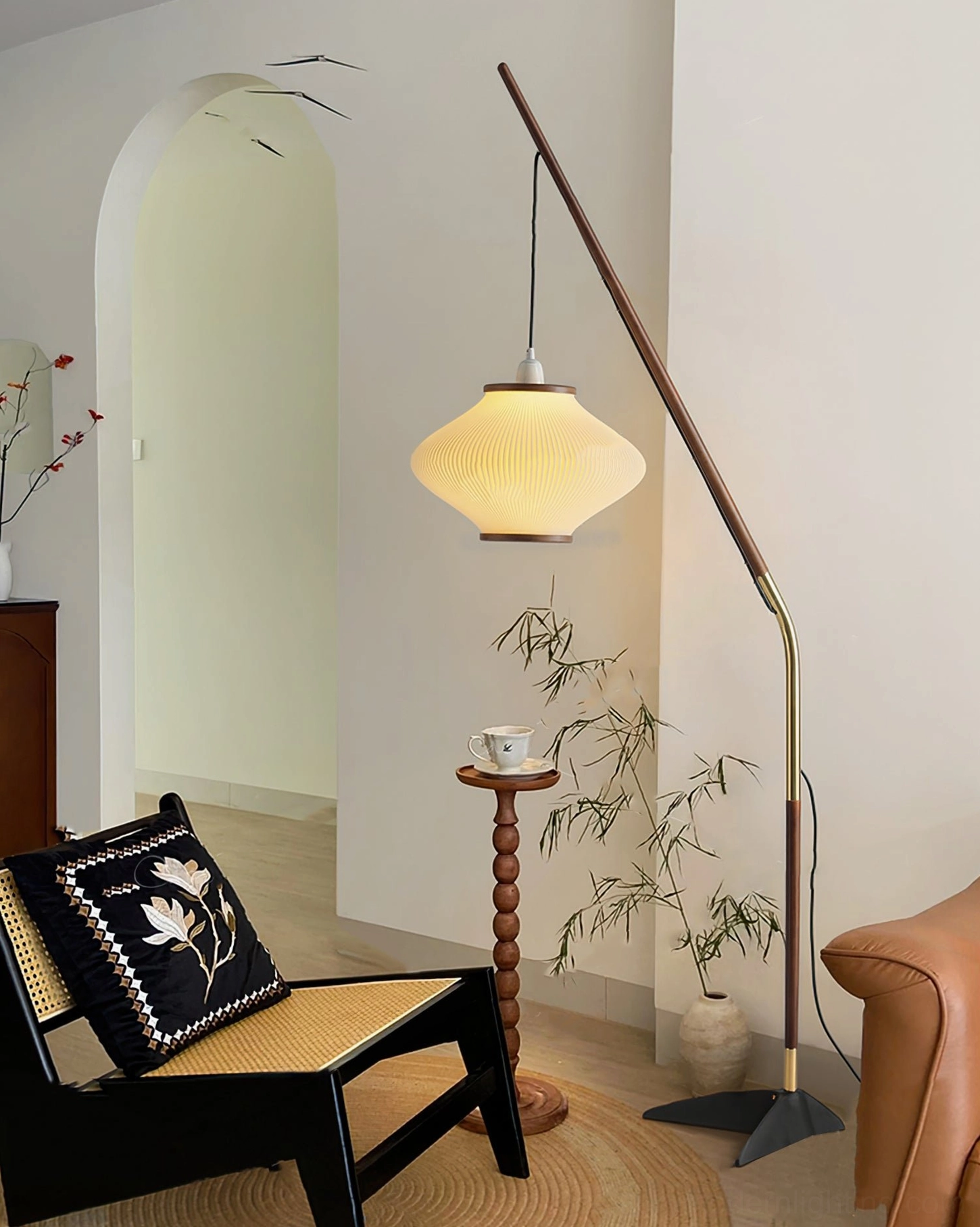 Matsusu arc floor lamp in bohemian modern living room with lounge chair and indoor plants warm lighting