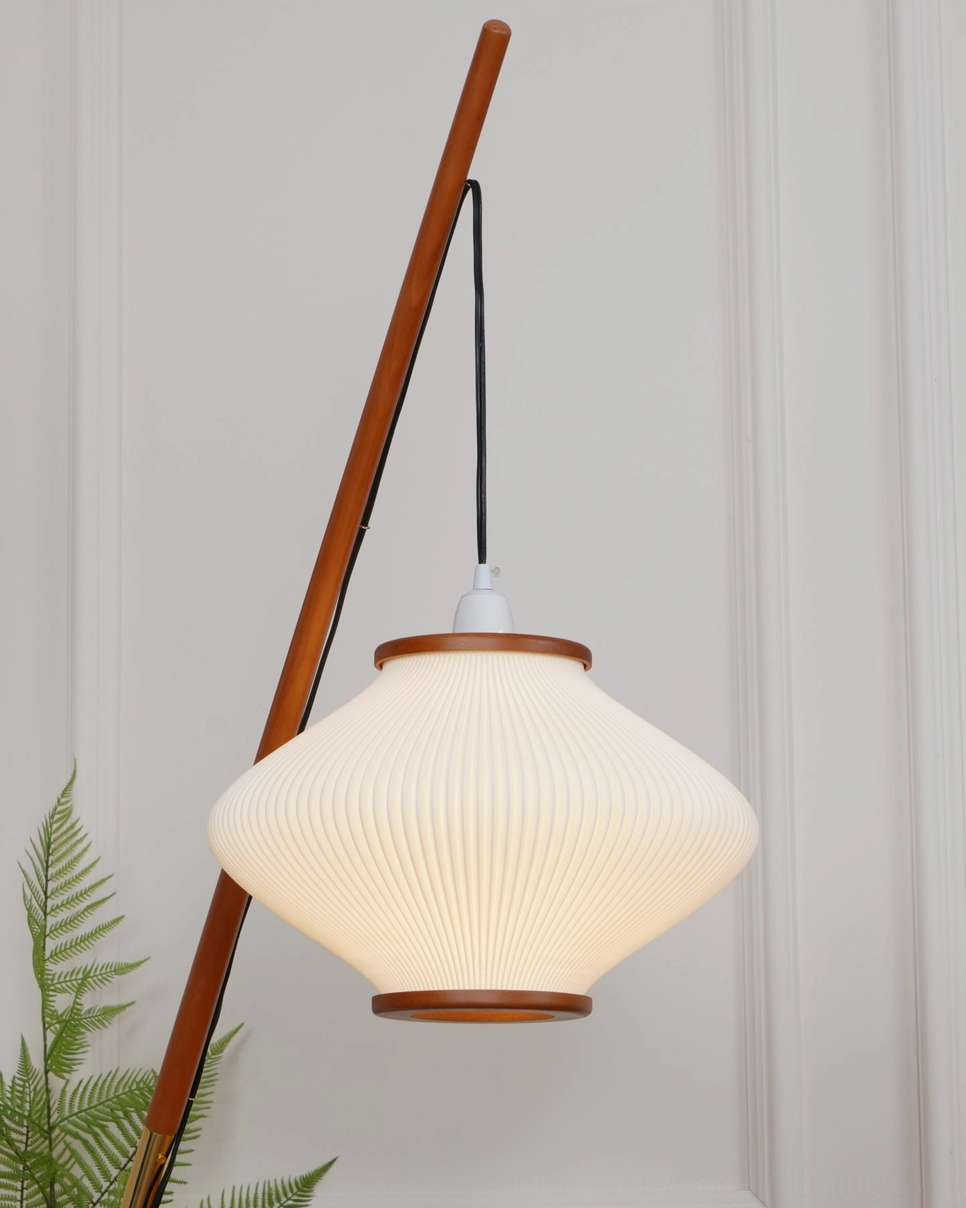Matsusu mid-century arc floor lamp in contemporary interior setting with warm ambient light