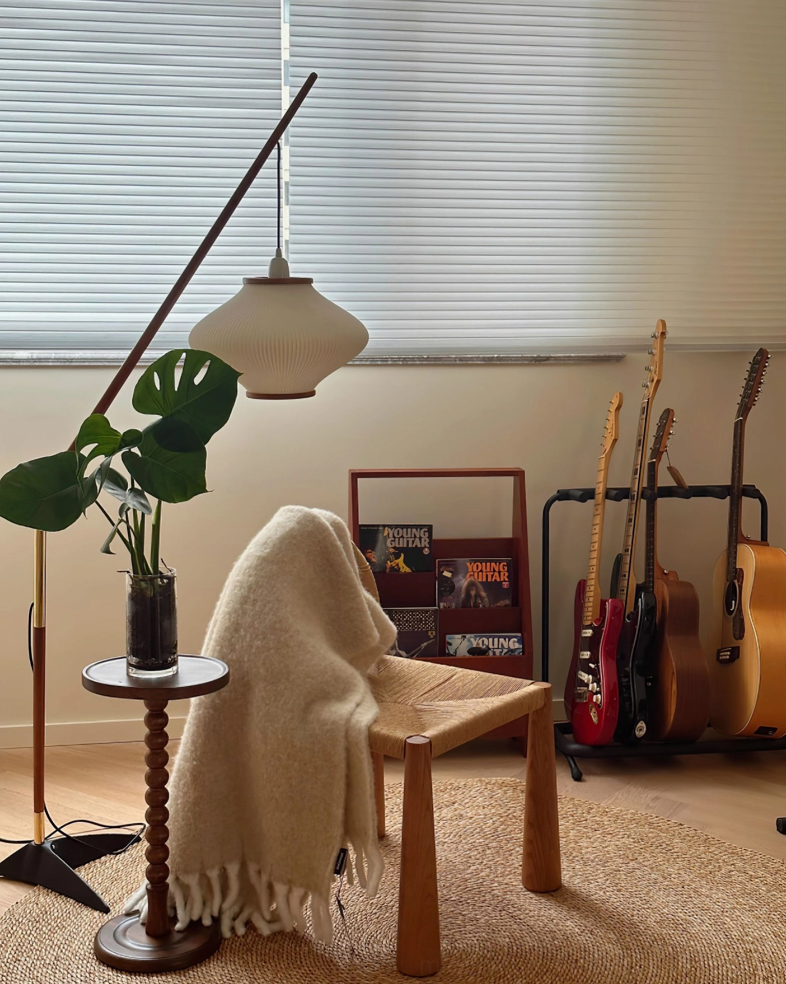 Matsusu arc floor lamp showcasing walnut wood finish and black metal base contrast