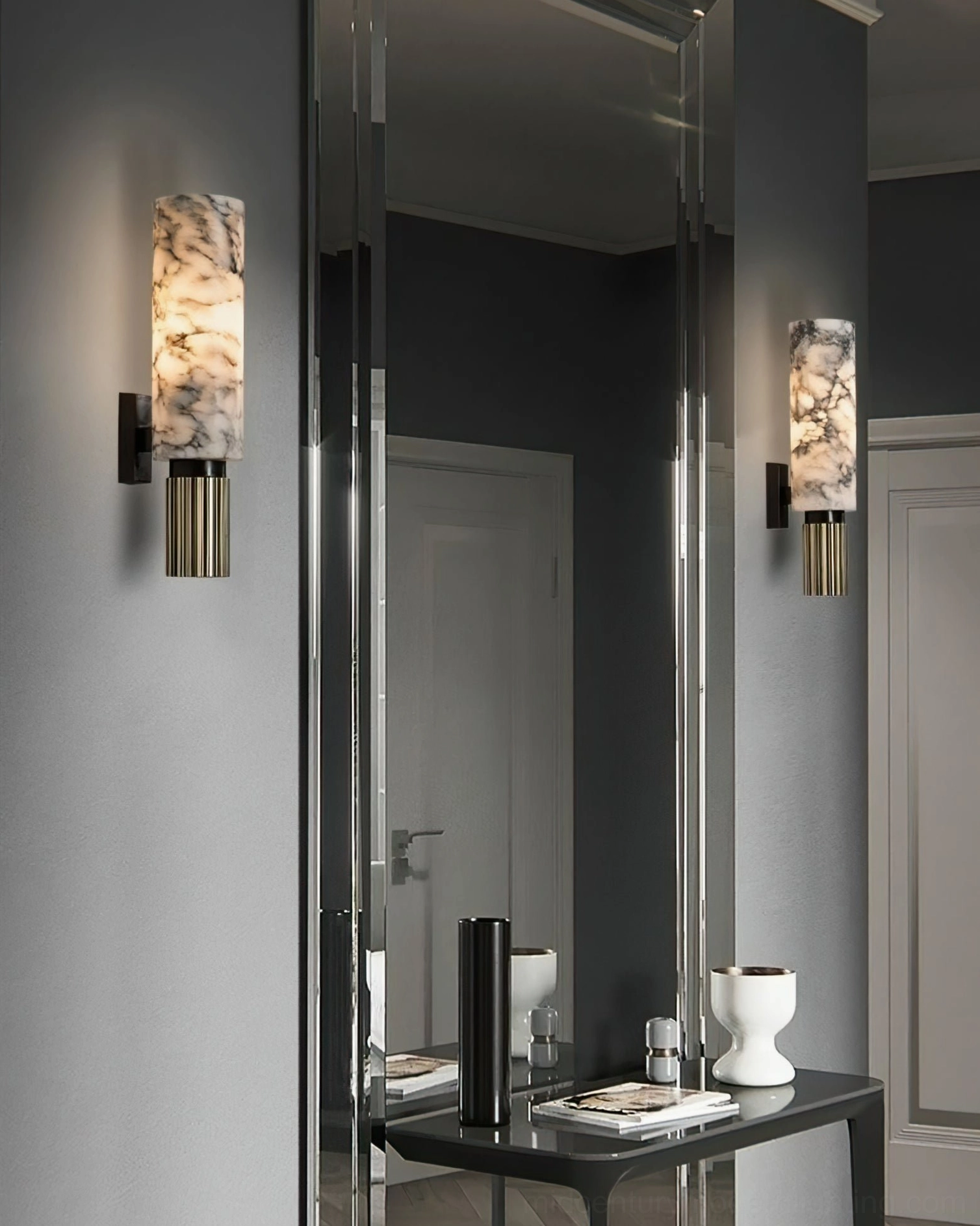 Alabaster wall lamp with matte black bracket and warm brass base finish in residential interior